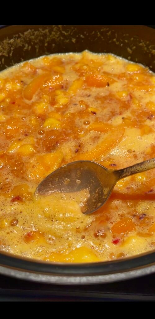 peach apricot lavender jam skimming foam from the surface during the second cook