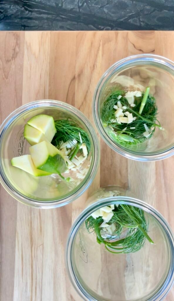 Garlic and dill go in first, right at the bottom of the jar.