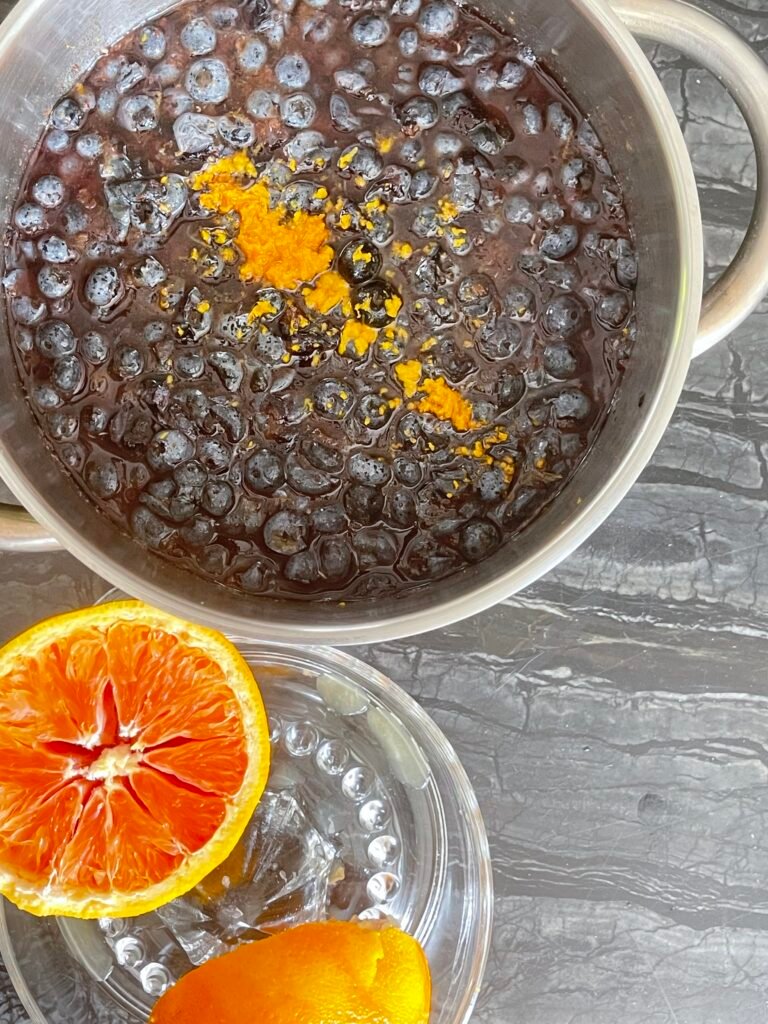 Blueberry Orange Jam — orange zest added to the pot, orange halved for juicing