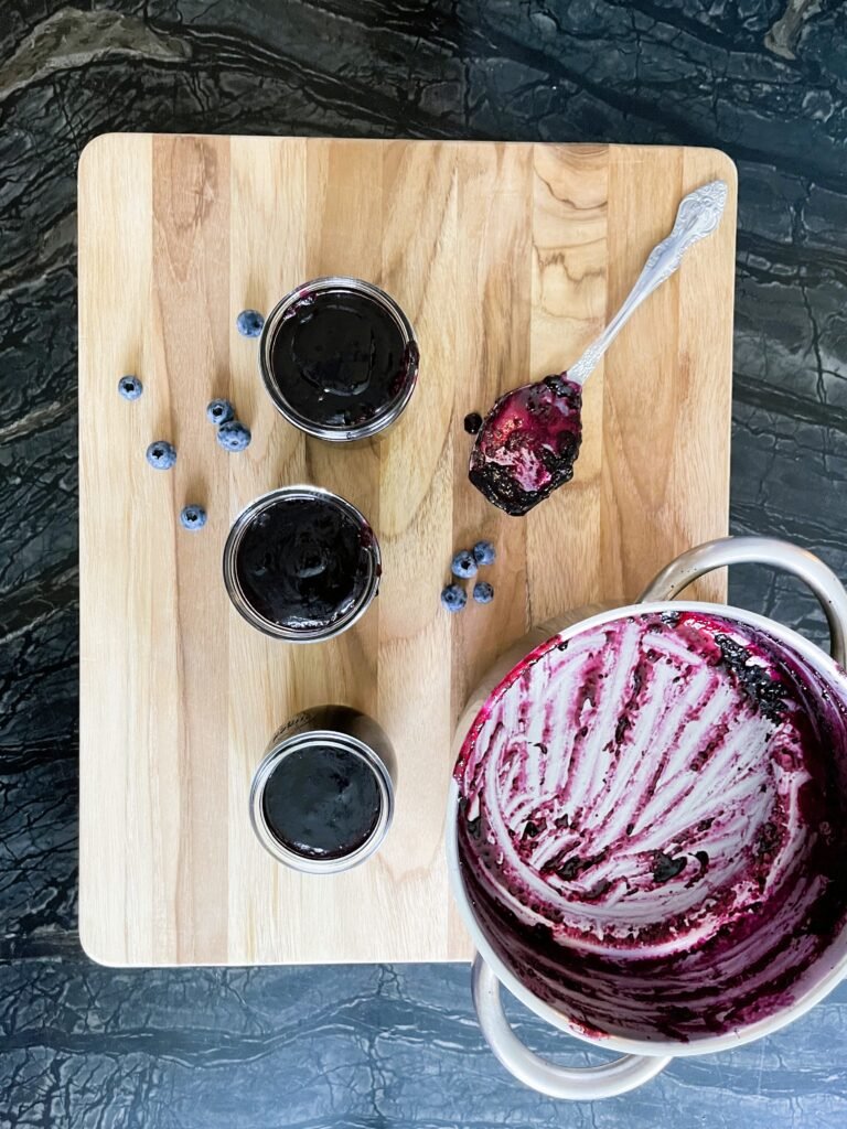 Canning Blueberry Orange Jam — filled jars sitting on the board