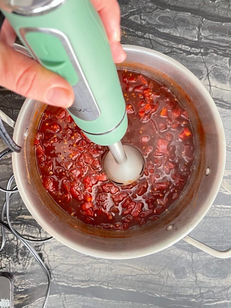 Tomato jam immersion blender smoothing cooked tomatoes