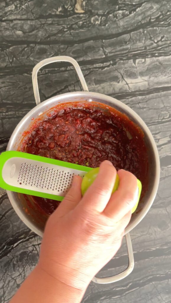 Tomato jam grating lime zest into the mixture