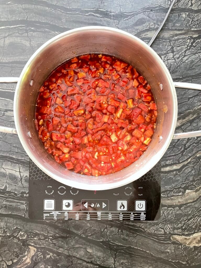 Tomato jam pot cooking down on the stovetop