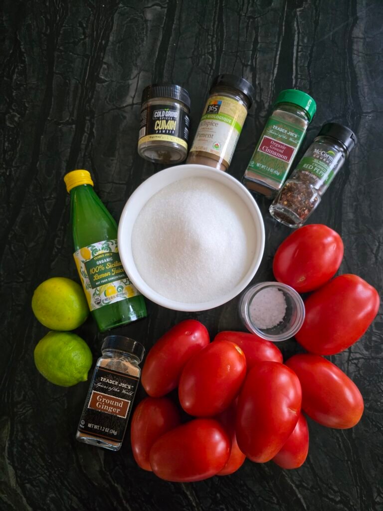 Tomato jam ingredients gathered: tomatoes, spices, sugar, and citrus
