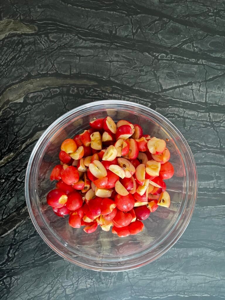 Glass bowl of quartered red crab apples for crab apple jelly